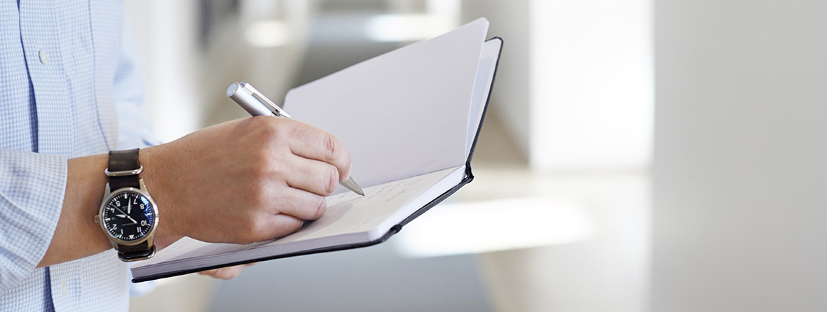 person holding an open notebook